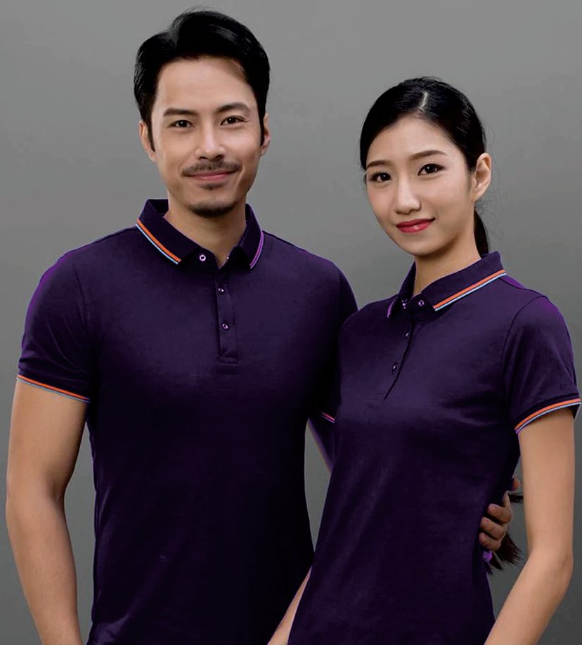 Two staff members in House Linen Bali branded purple polo shirts